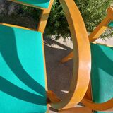 3 vintage bridge chairs with rounded armrests.