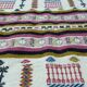 Handmade Berber kilim rug with multicoloured tribal motifs.