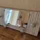 Wall-mounted coat rack with a patinated mirror