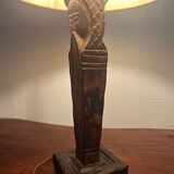 Old lamp with carved wooden base representing a wise man