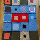 Hand-knitted patchwork blanket