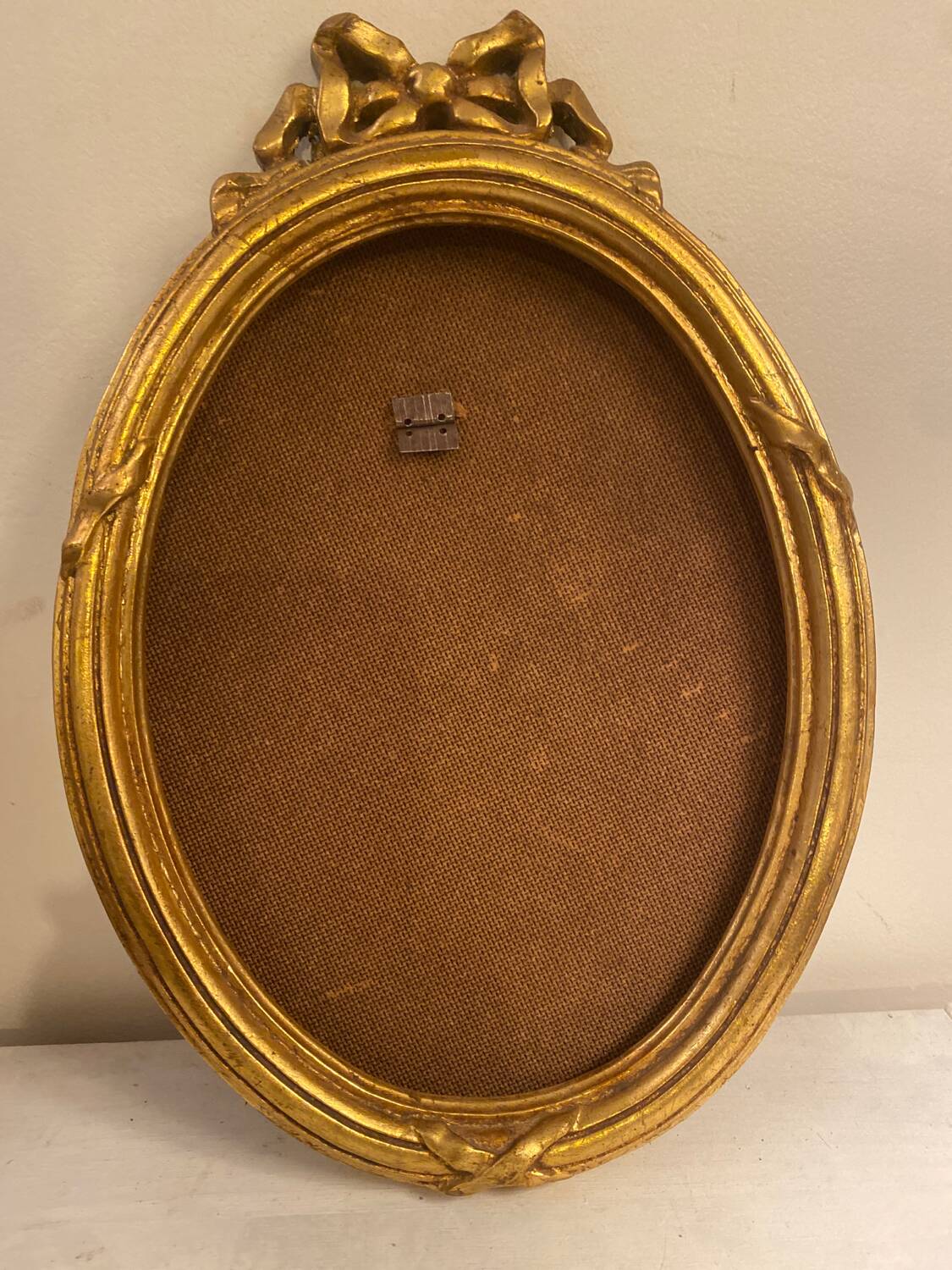 Golden oval wooden frame