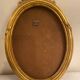 Golden oval wooden frame