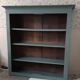Wood and khaki green bookcase