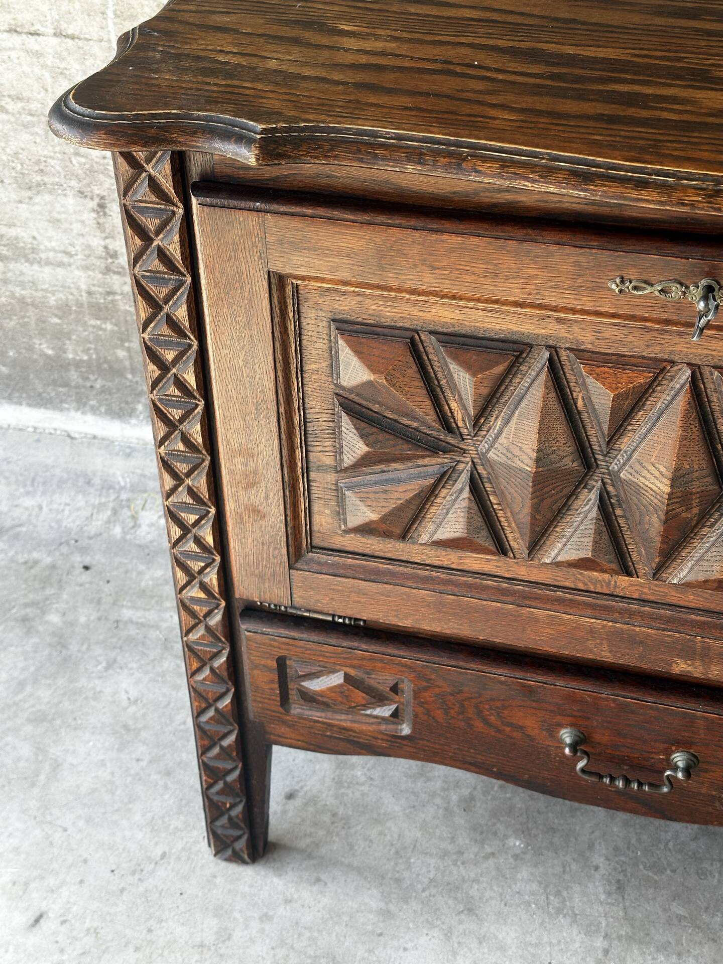 Small storage cabinet in carved oak – circa 1930