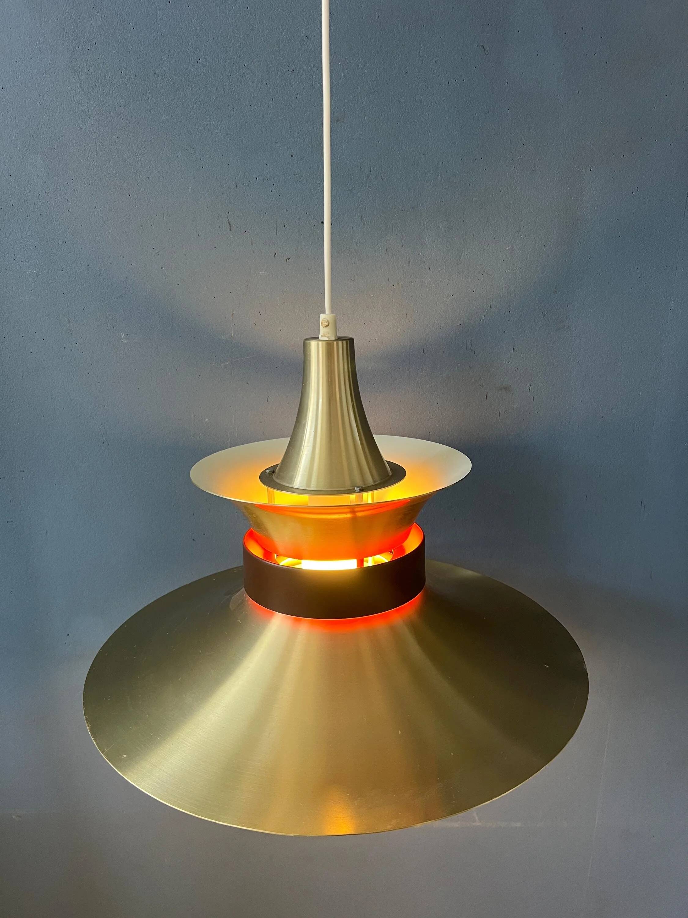 Large UFO flying saucer pendant light with orange light.