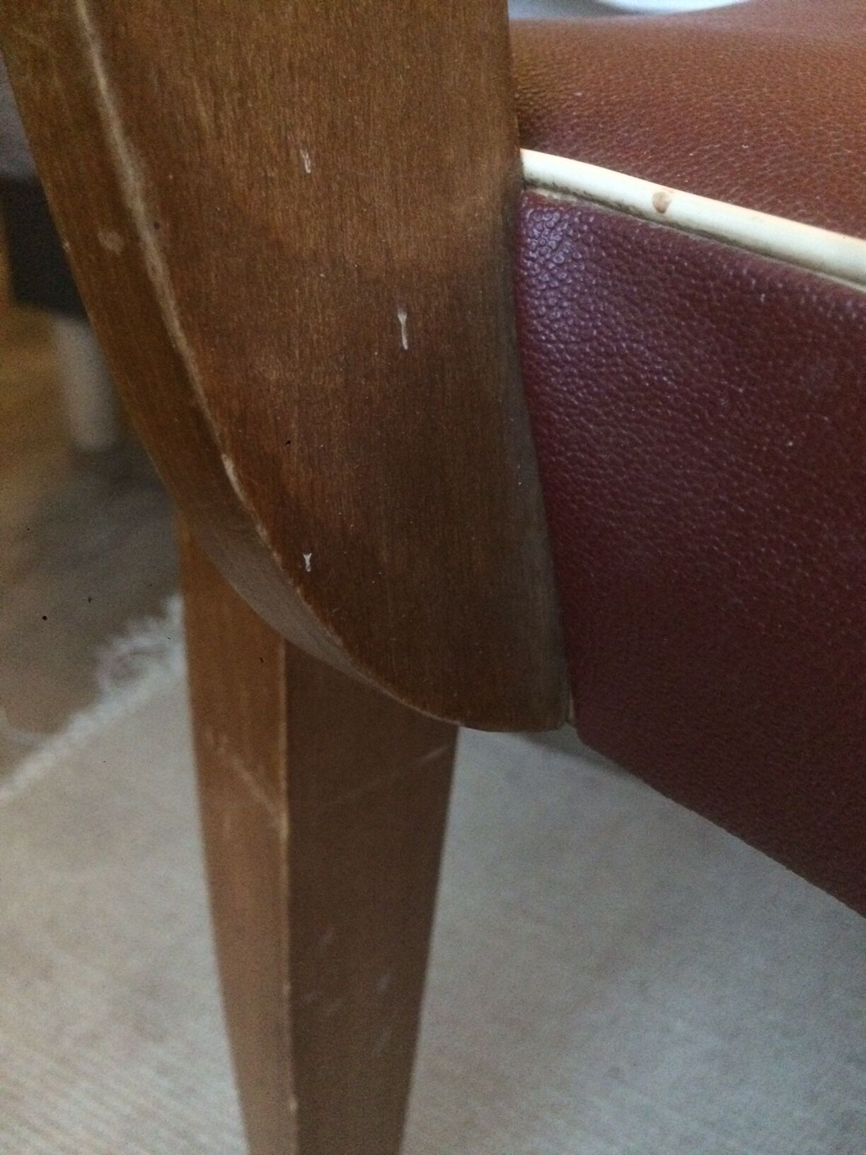Skai chair binds wine and wooden footpieces and armrests