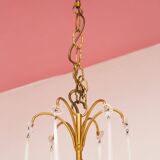 Large golden Italian chandelier with white opaline drops.