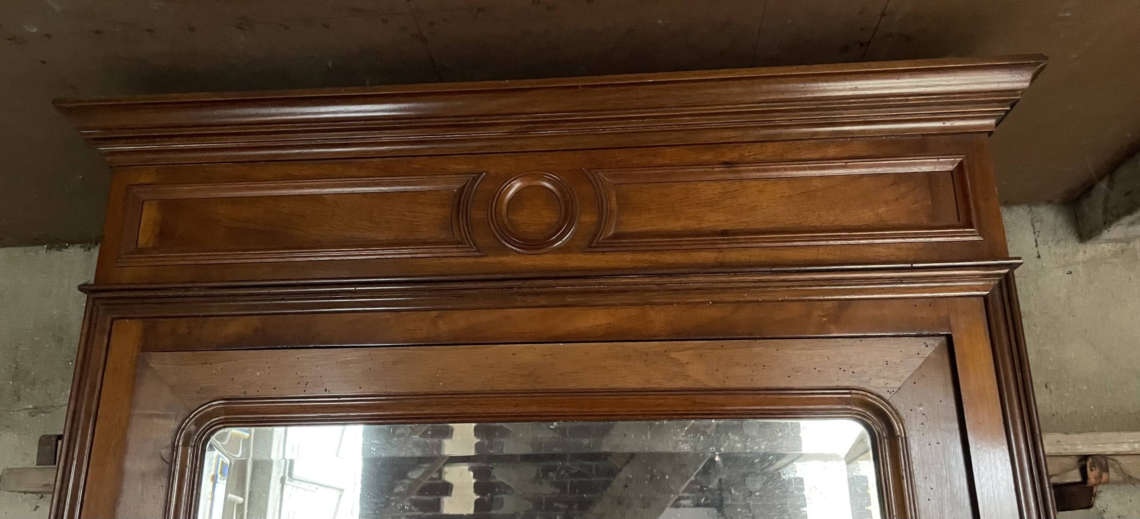 Antique wardrobe with a mirror door.