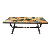 Vintage stone coffee table with a cast iron frame.