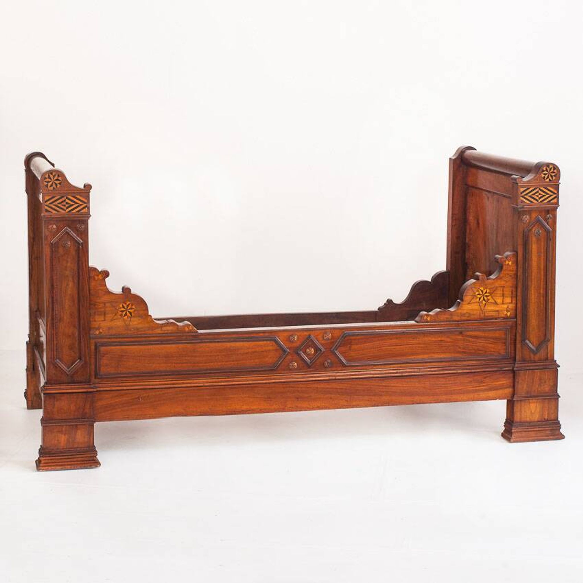 Bed made of solid walnut with marquetry details. France, 1930s.