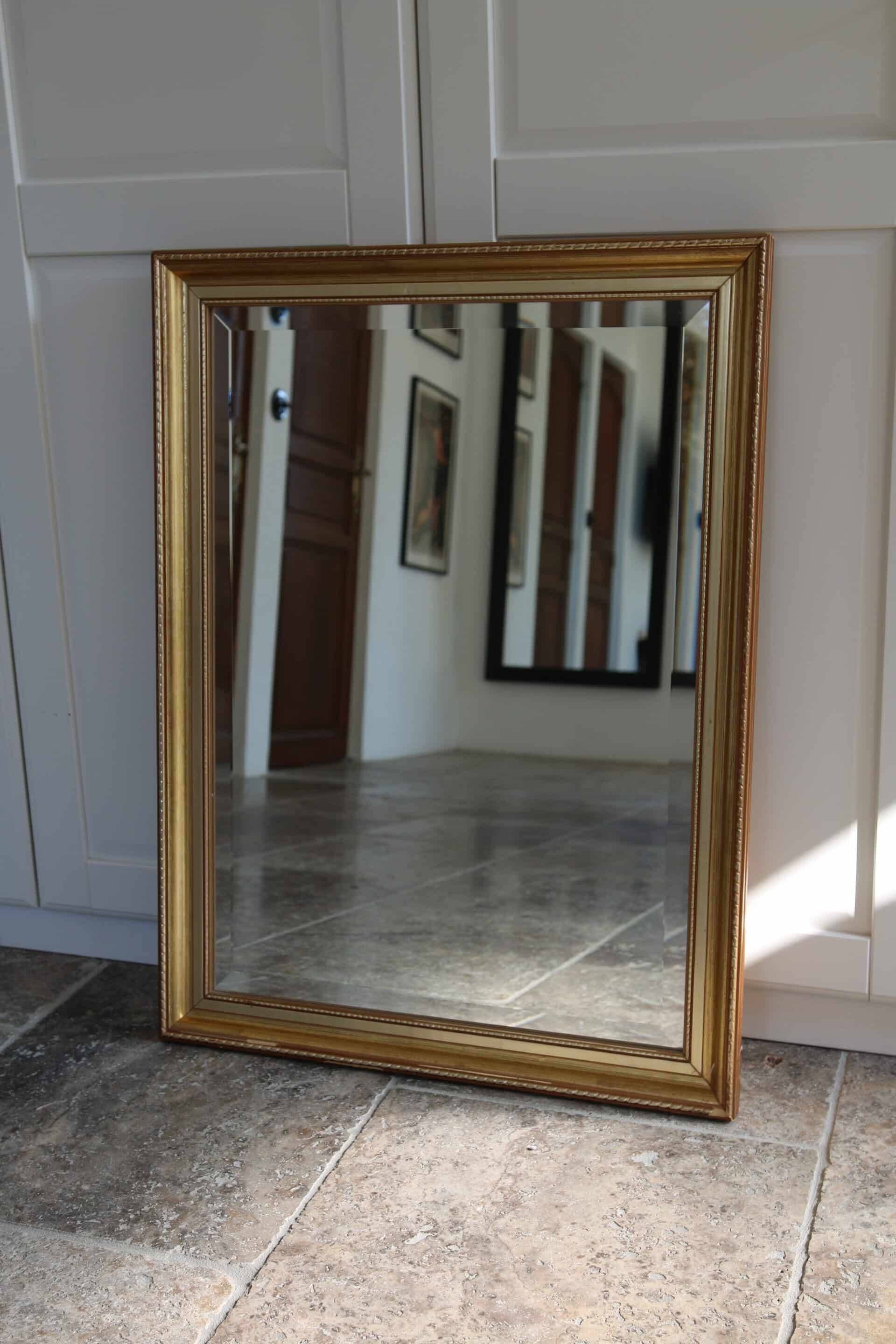 Large beveled mirror in carved wood