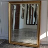 Large beveled mirror in carved wood