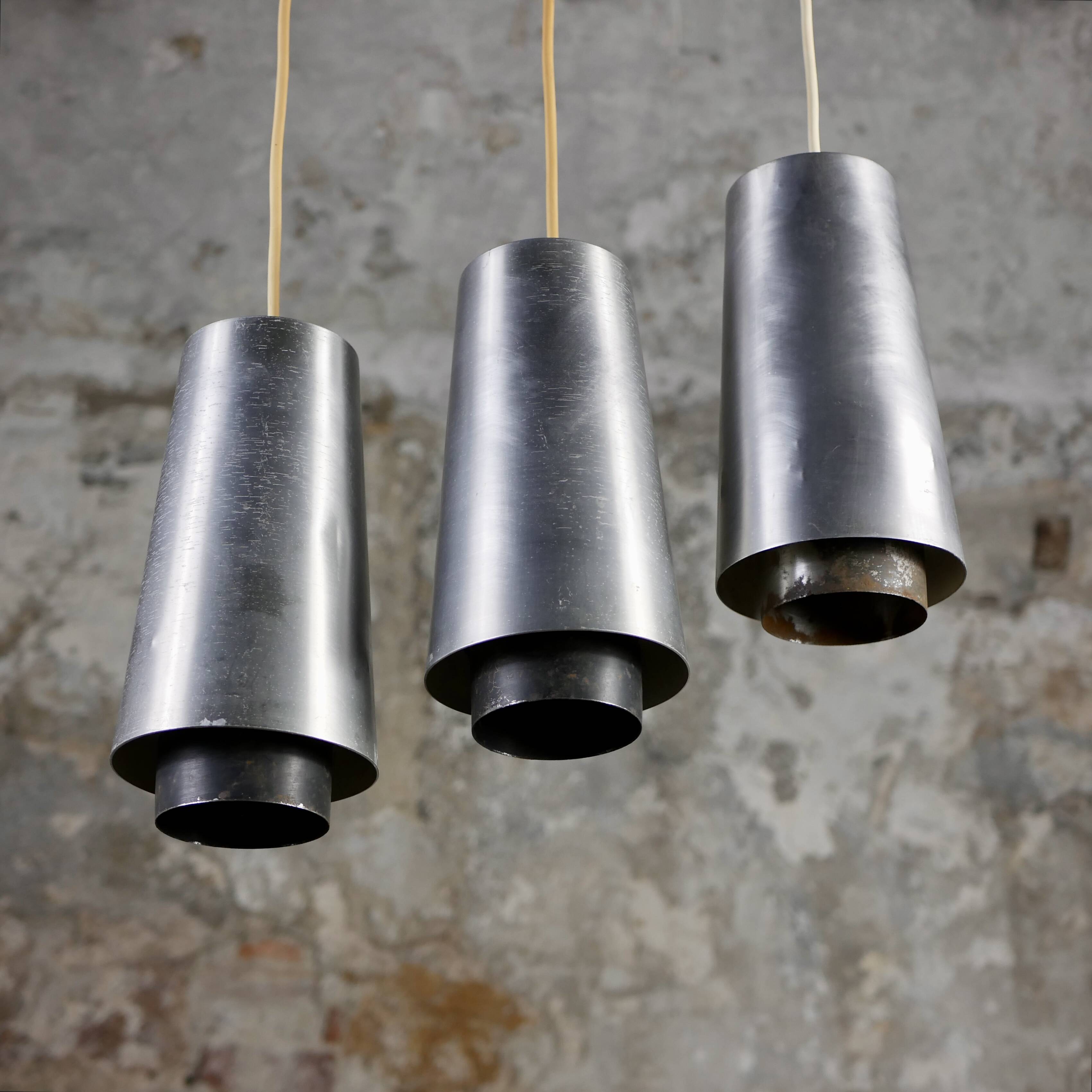 Trio of Raak steel pendant lights, 1960s