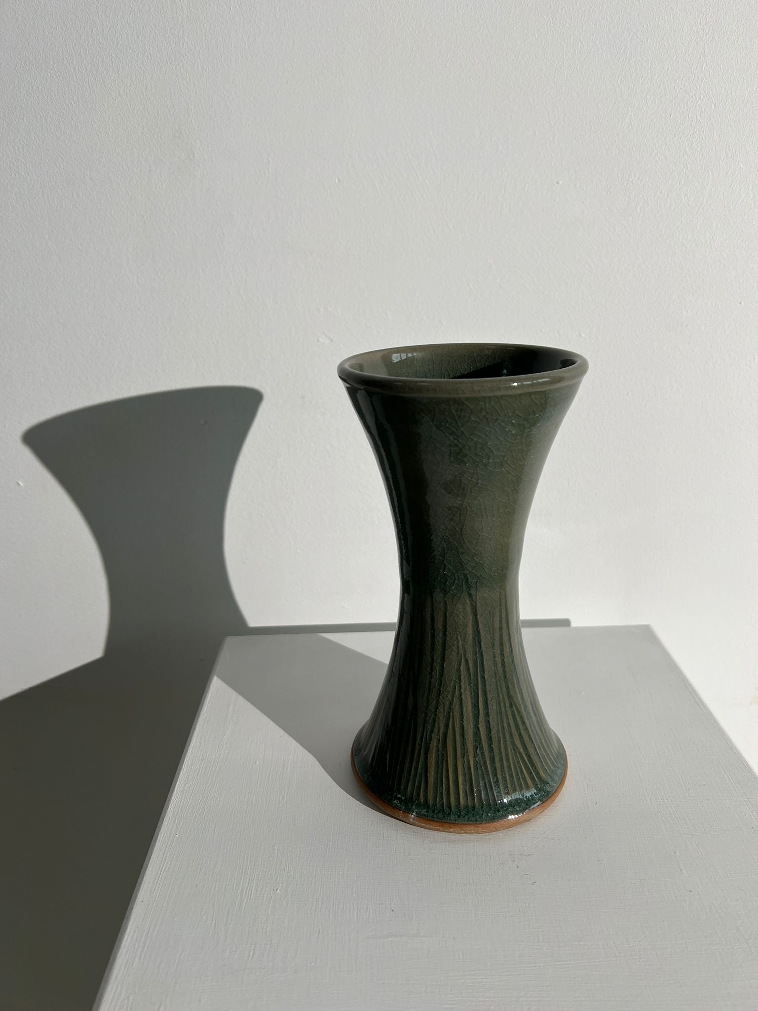 Dark green handcrafted vase with glazed ceramic grass blades