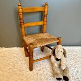 Old, rustic children's chair, small wooden and straw chair.