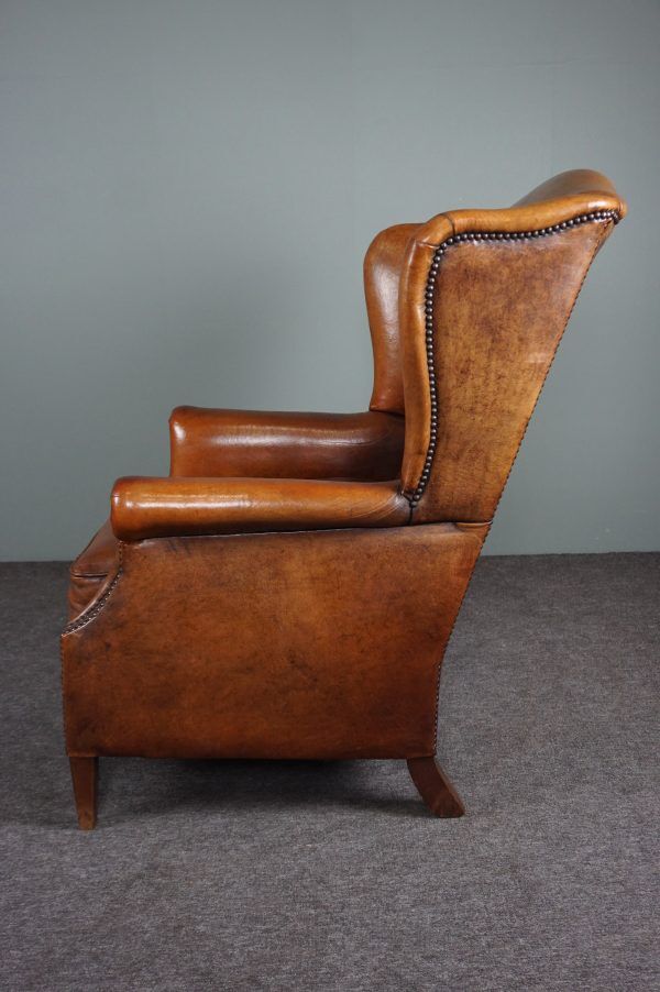 Eared armchair in patinated sheepskin