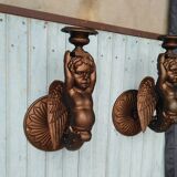 Paire de torchères murales putti en fonte
