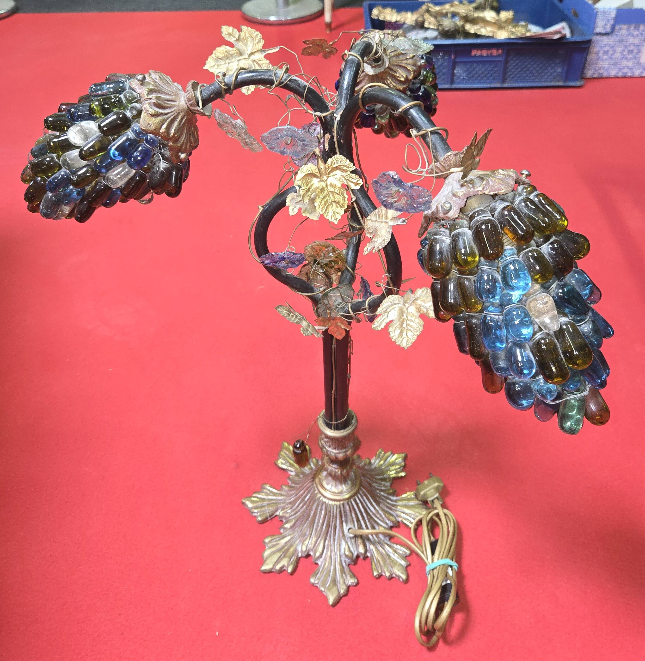 Decorative table lamp in the shape of coloured glass grape clusters.