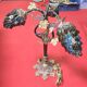 Decorative table lamp in the shape of coloured glass grape clusters.