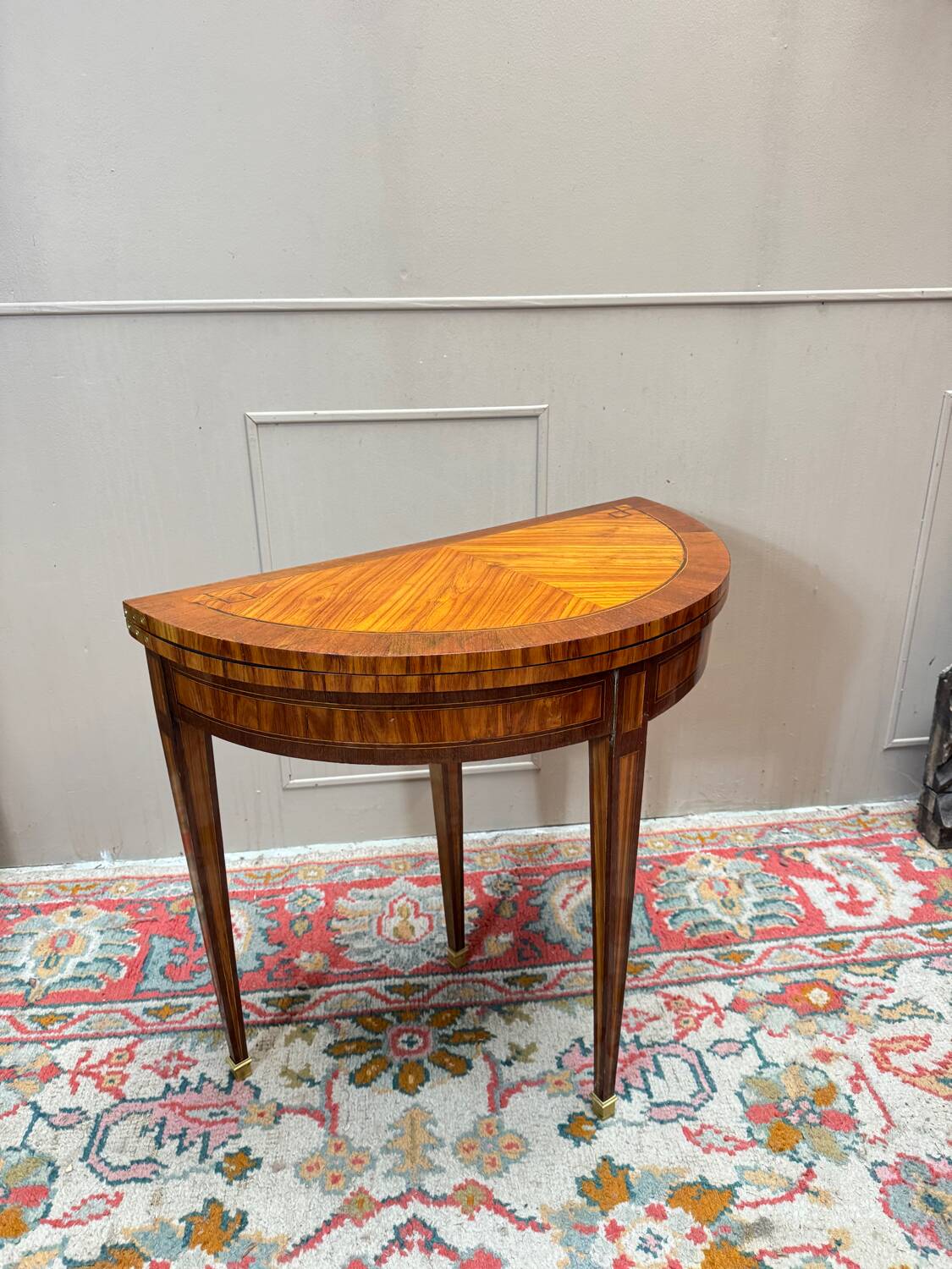 Half-moon game table in marquetry from the Louis XVI period, 18th century.