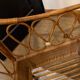 Vintage rattan baby cot on wheels.