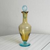 Old glass vial in yellow and blue.