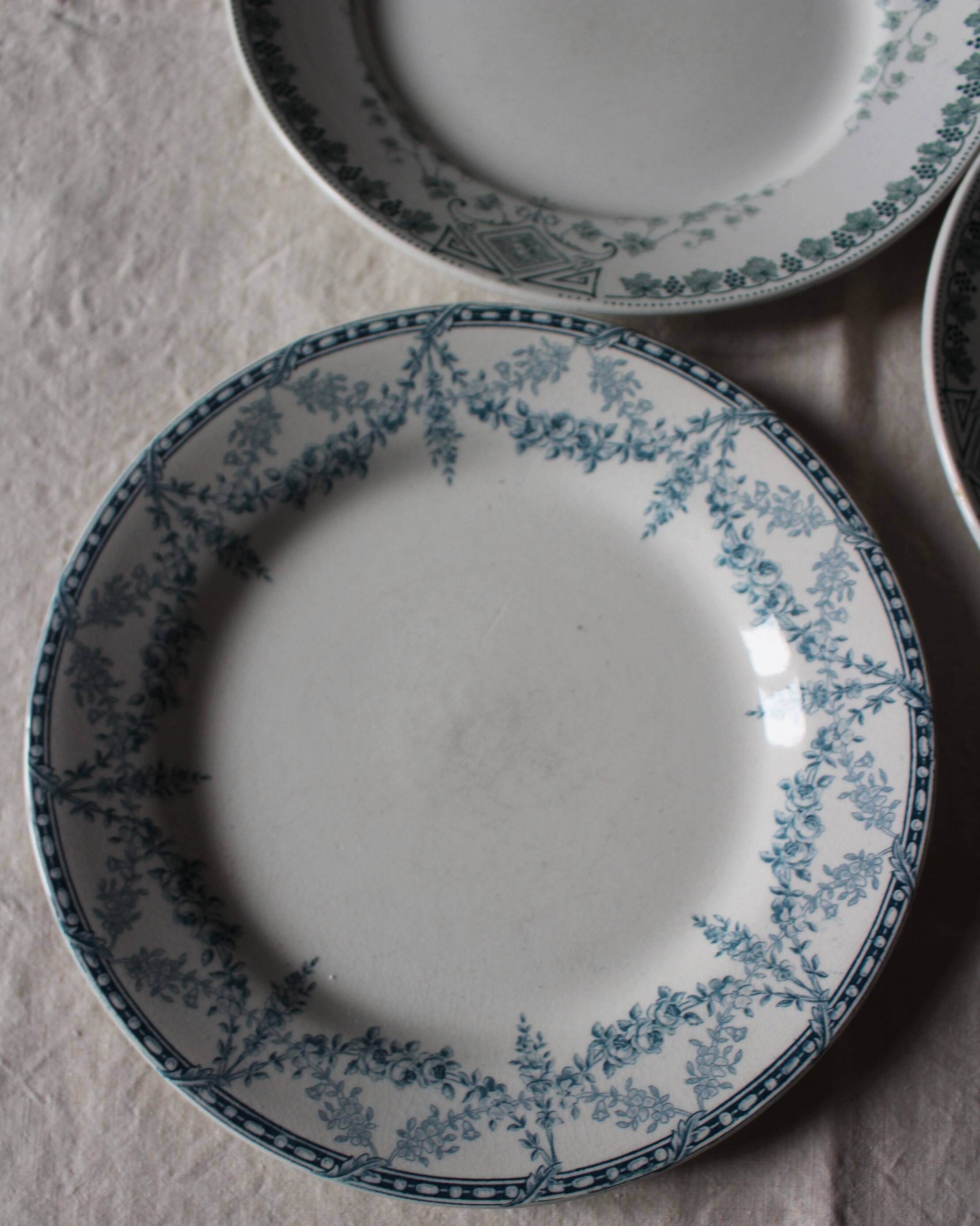 A set of 5 mismatched green blue Terre de fer flat plates