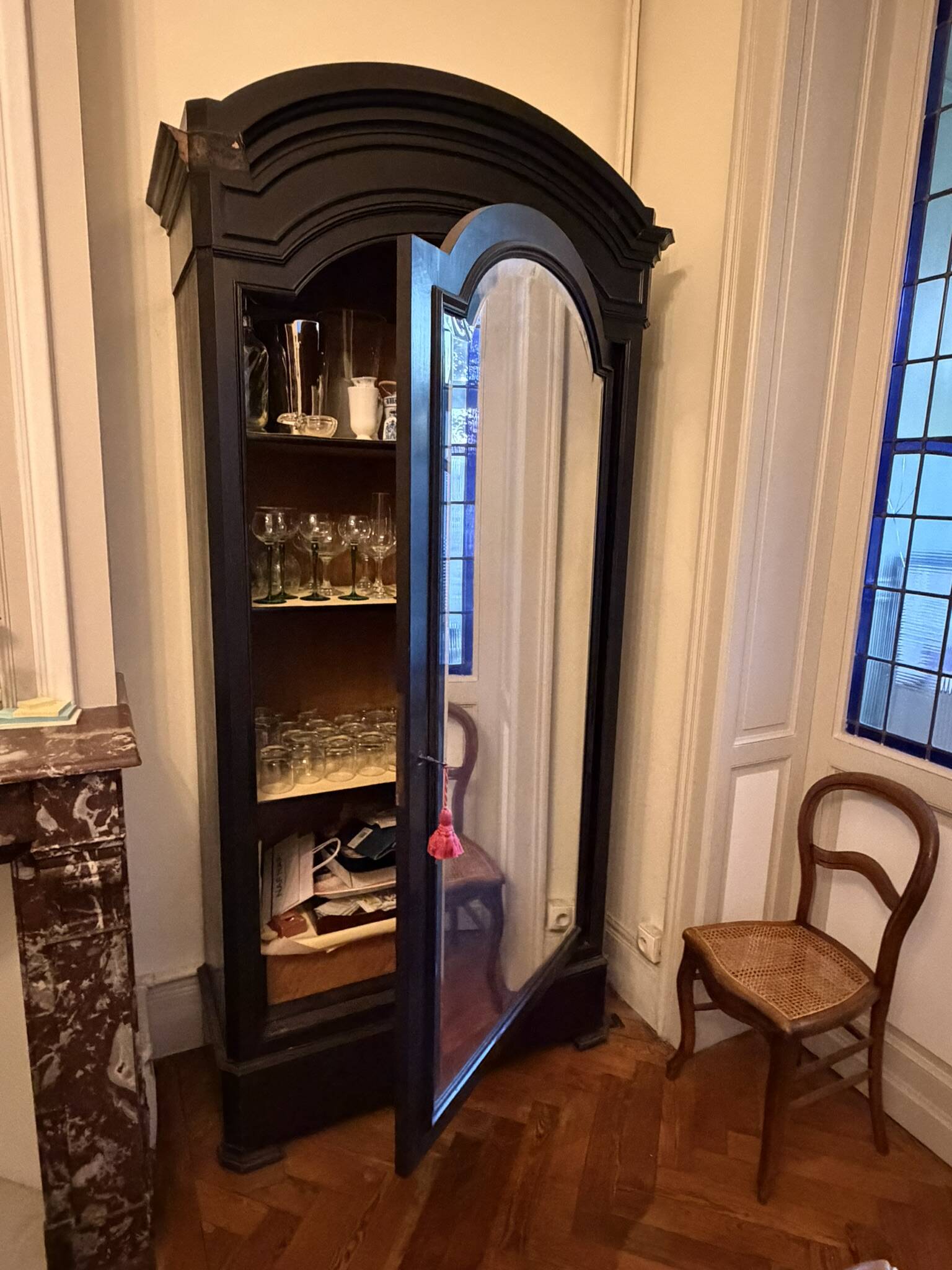 Black wardrobe with a mirrored door in ebony finish.
