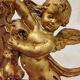 Antique mirror with a gilded frame and cherubs.