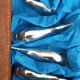 Lot 12 knife holders in the shape of a stylized whale or fish