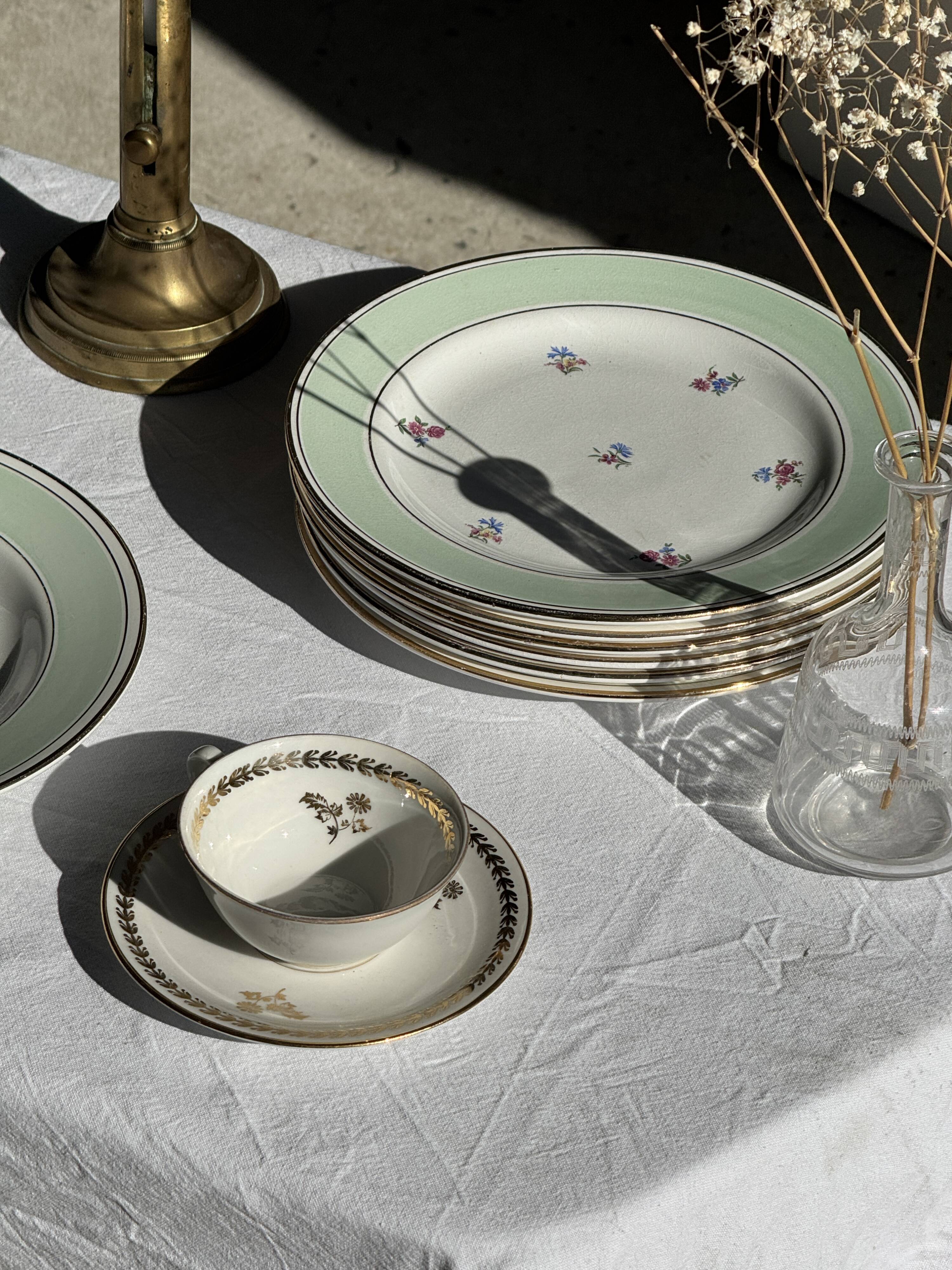 Set of 9 vintage turquoise deep plates with gold trim and pink flowers.