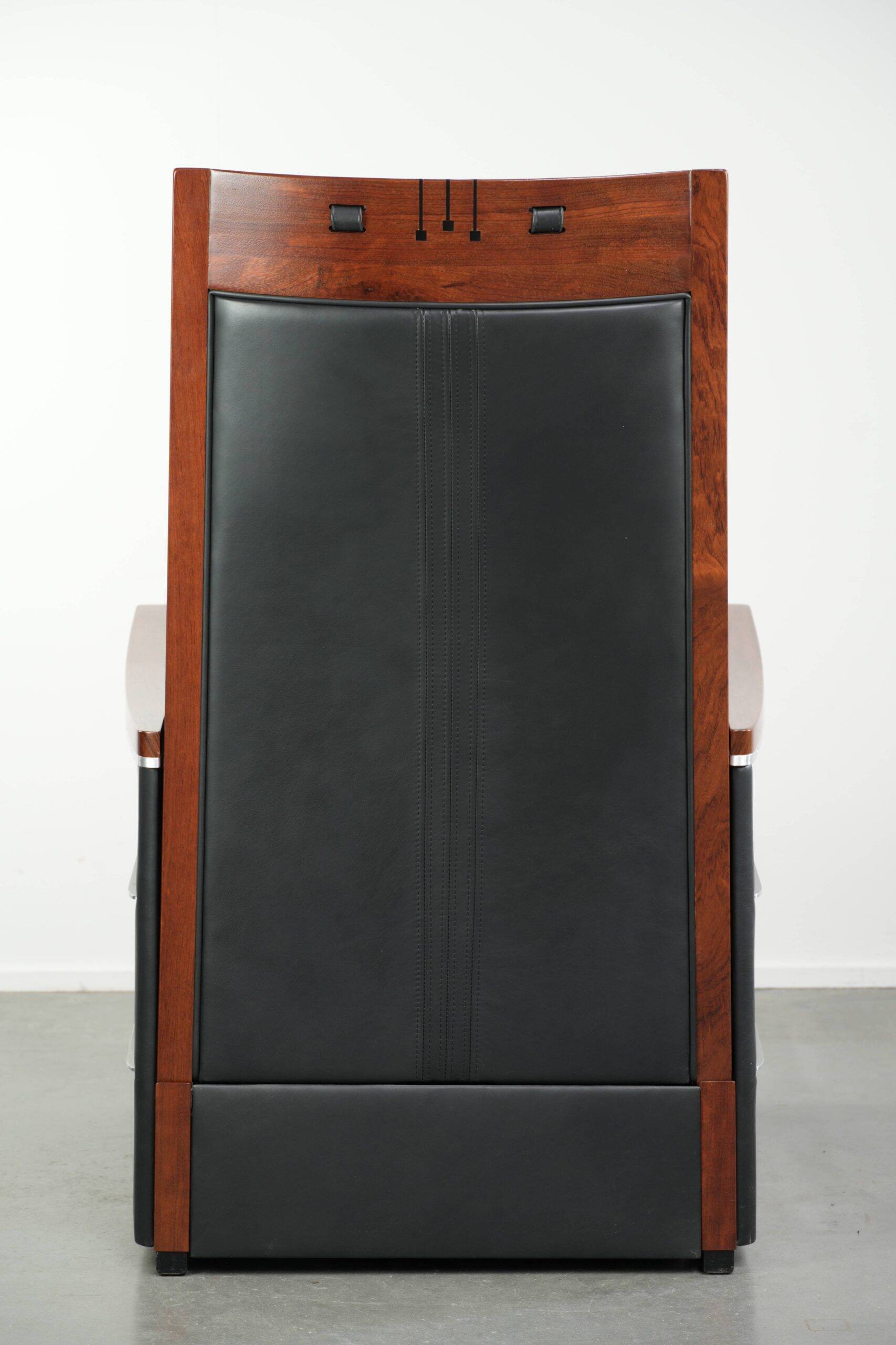 Electrically adjustable Art Deco design recliner with black cowhide leather