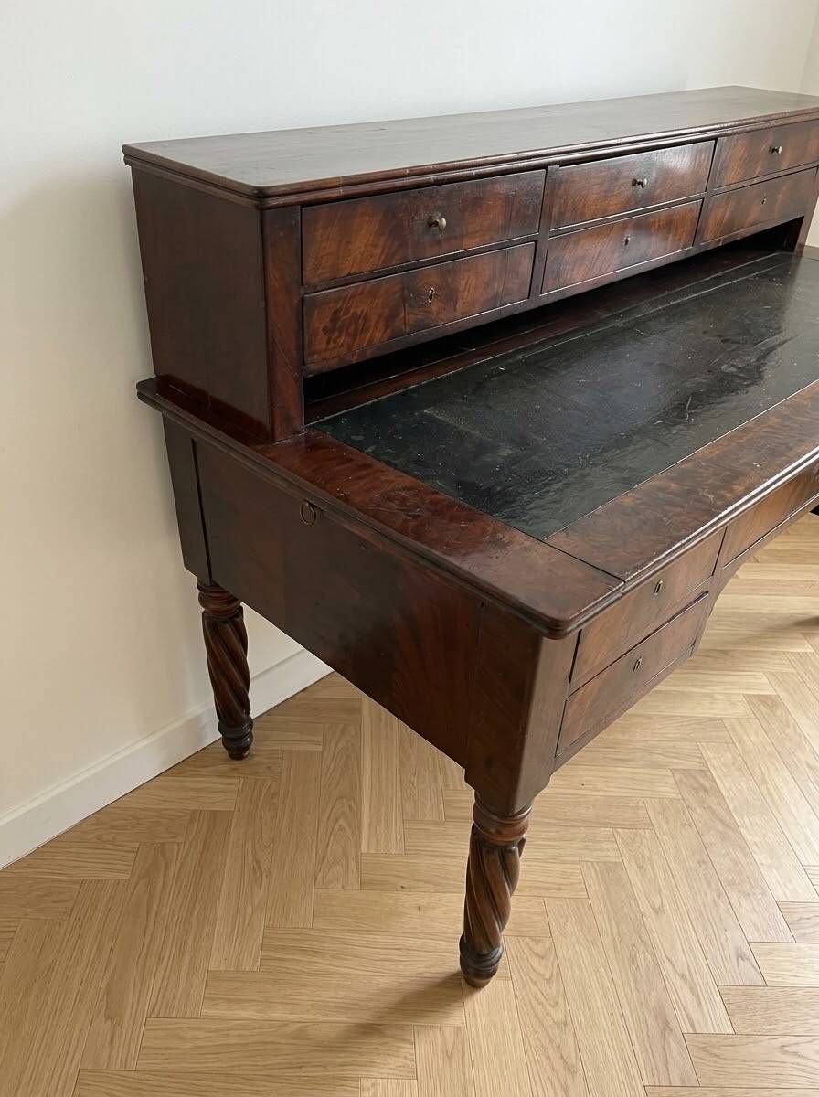 Antique wooden tiered desk with drawers and twisted legs.
