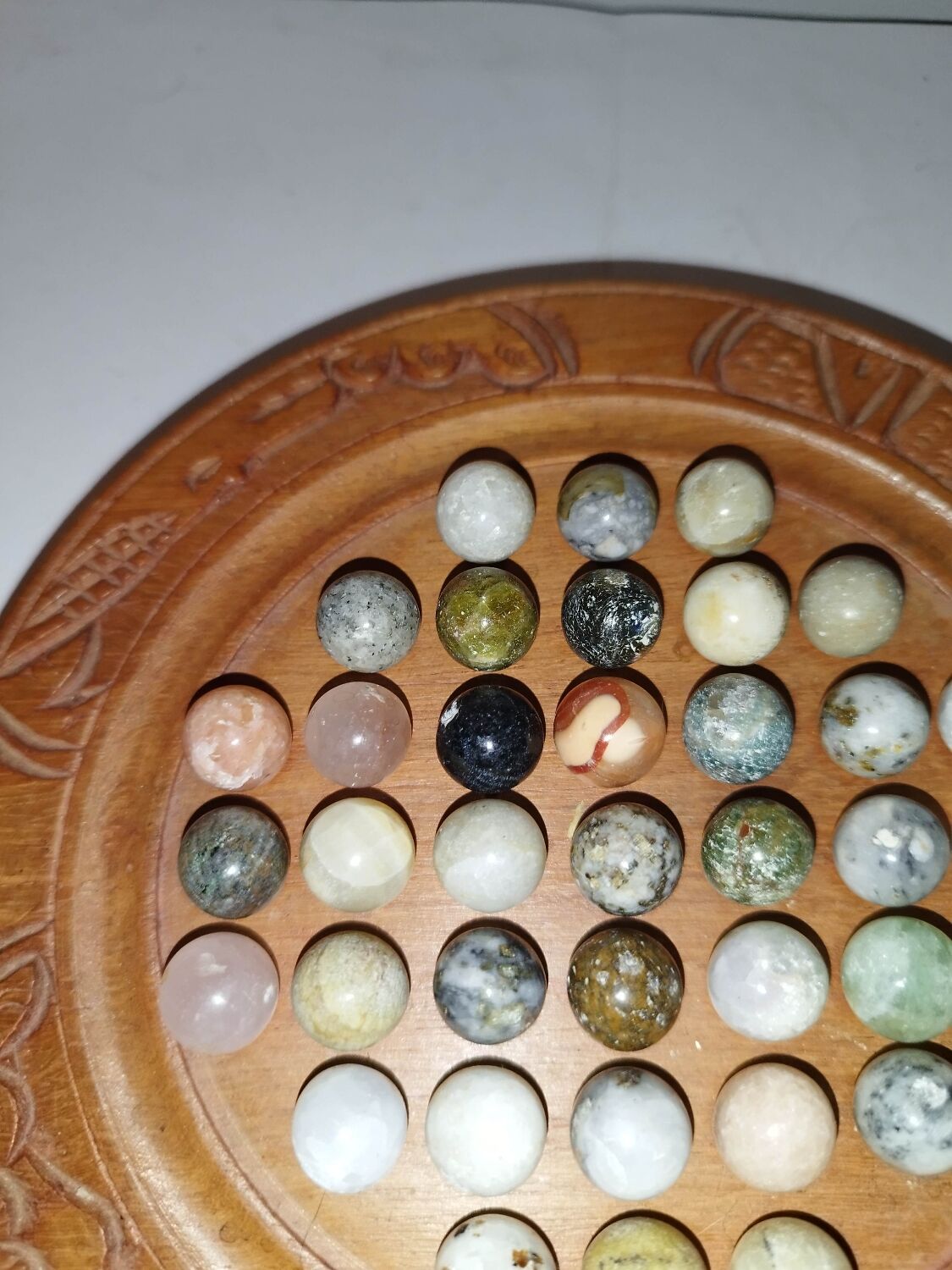 Ancient solitaire game in wood and stone marbles
