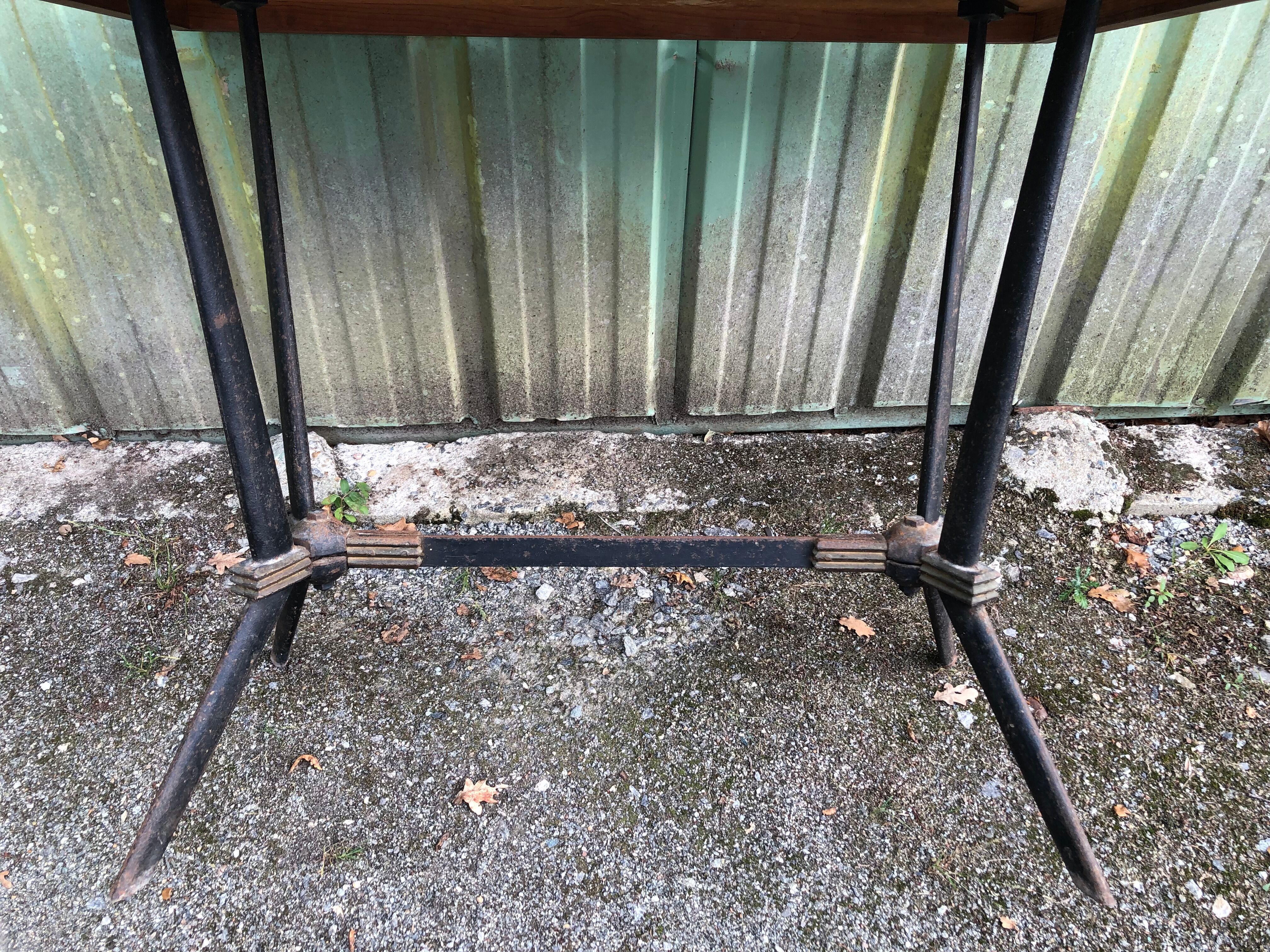 Vintage bistro table with an Art Deco style cast iron base and Formica top.