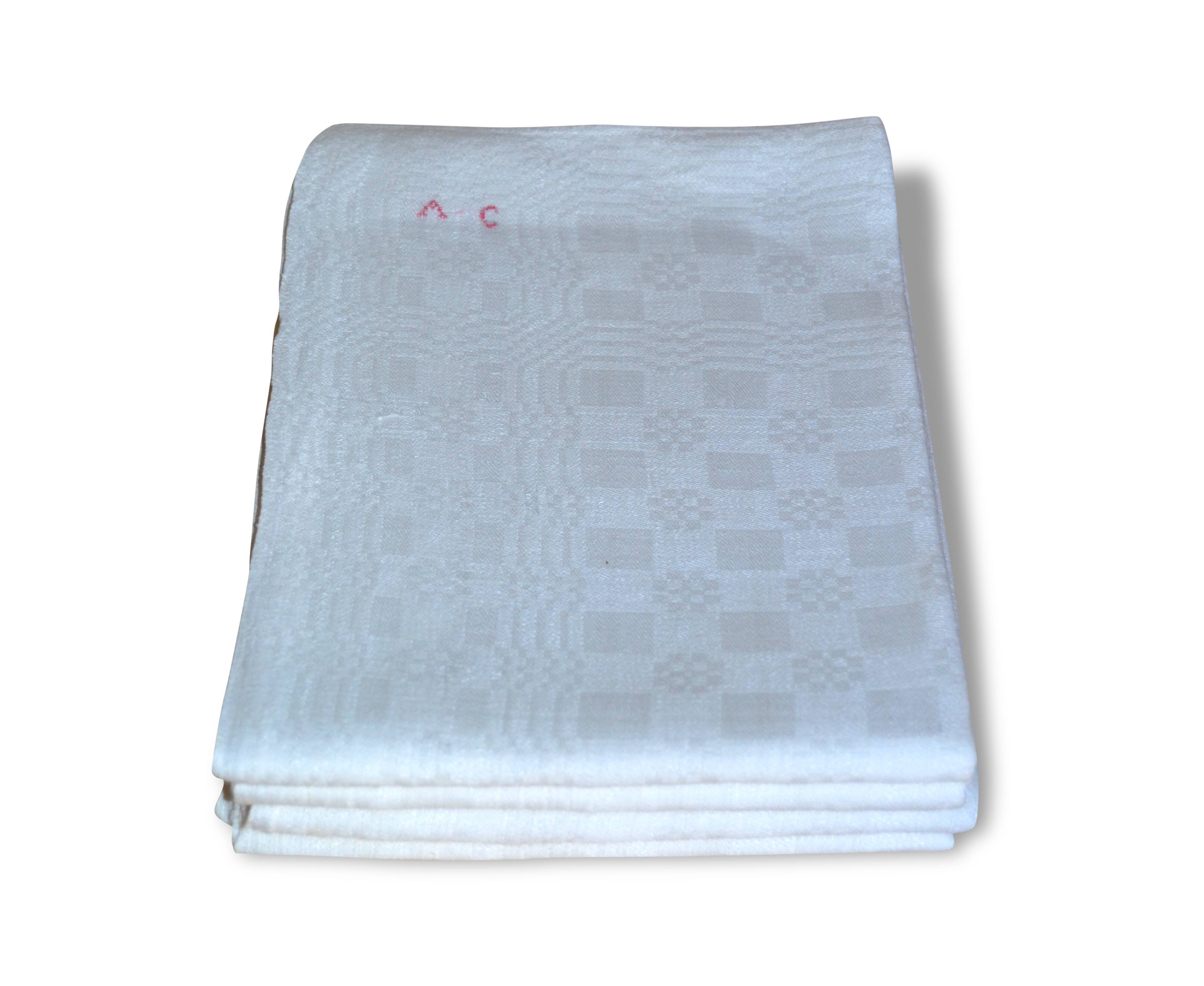 Suite of four former cloths, red AC monograms