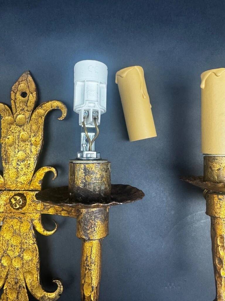 Pair of electrified golden wrought iron gothic wall sconces.
