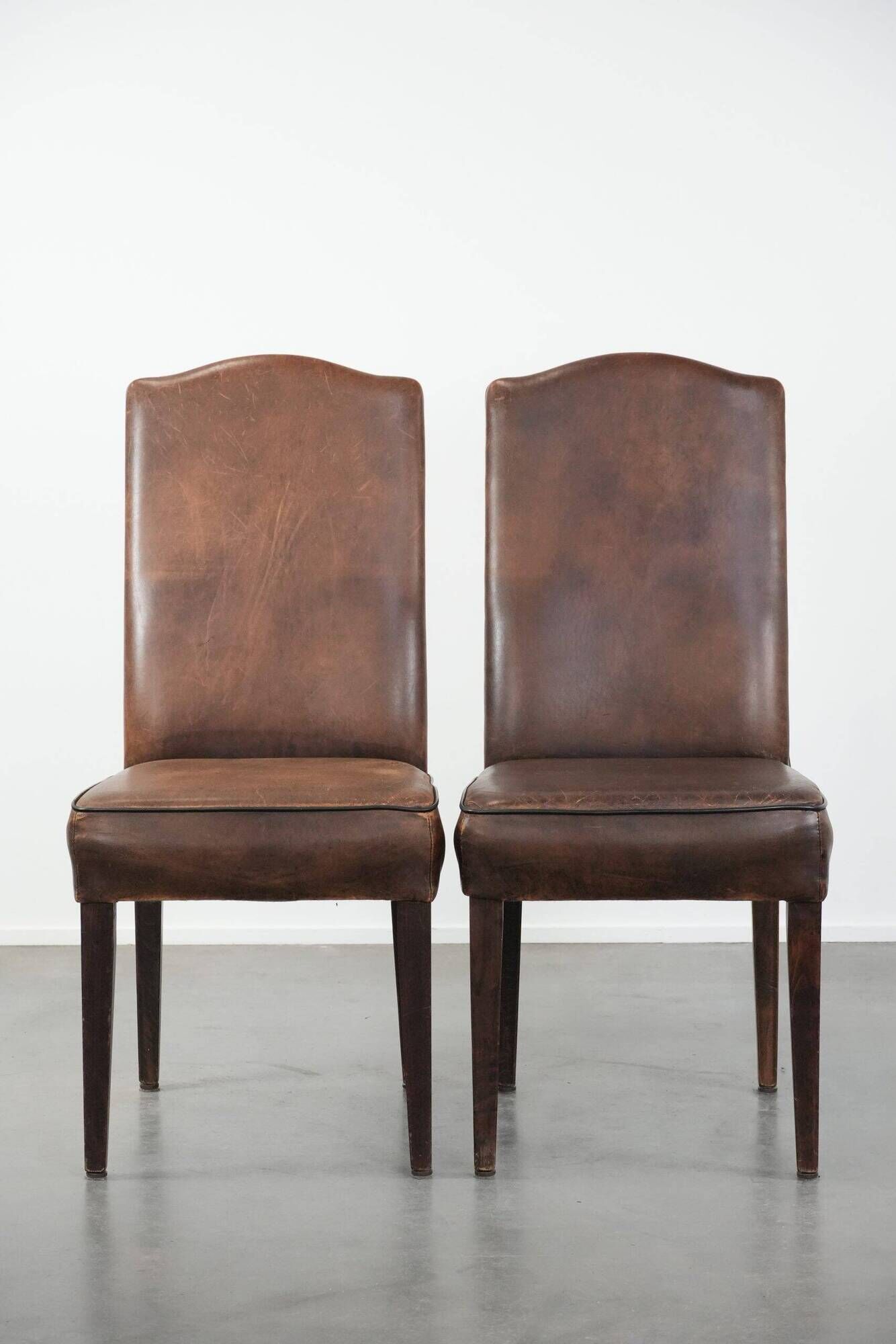 Set of 6 vintage sheepskin dining chairs finished with black piping