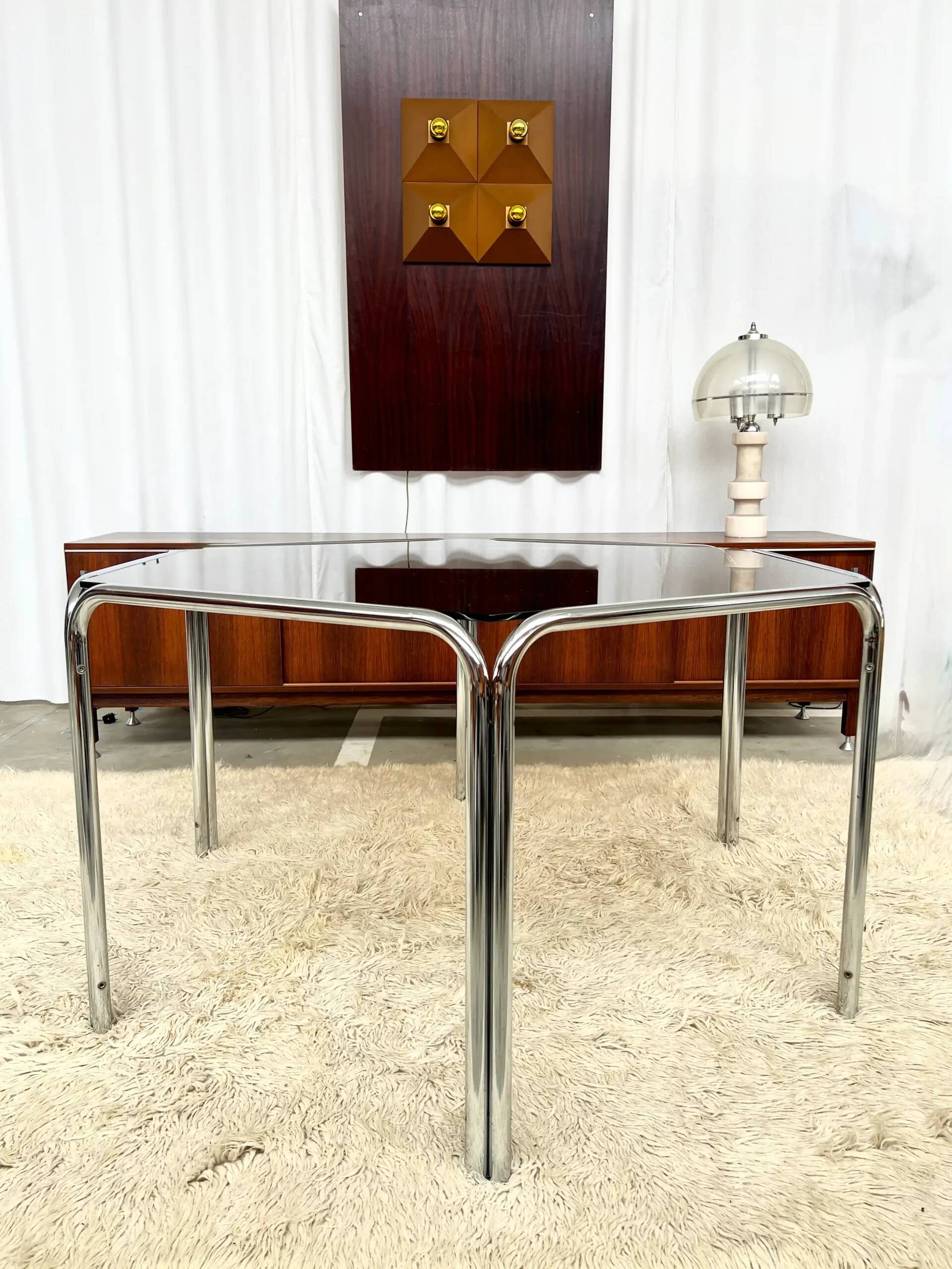 Vintage hexagonal table with smoked glass top and chrome metal structure.