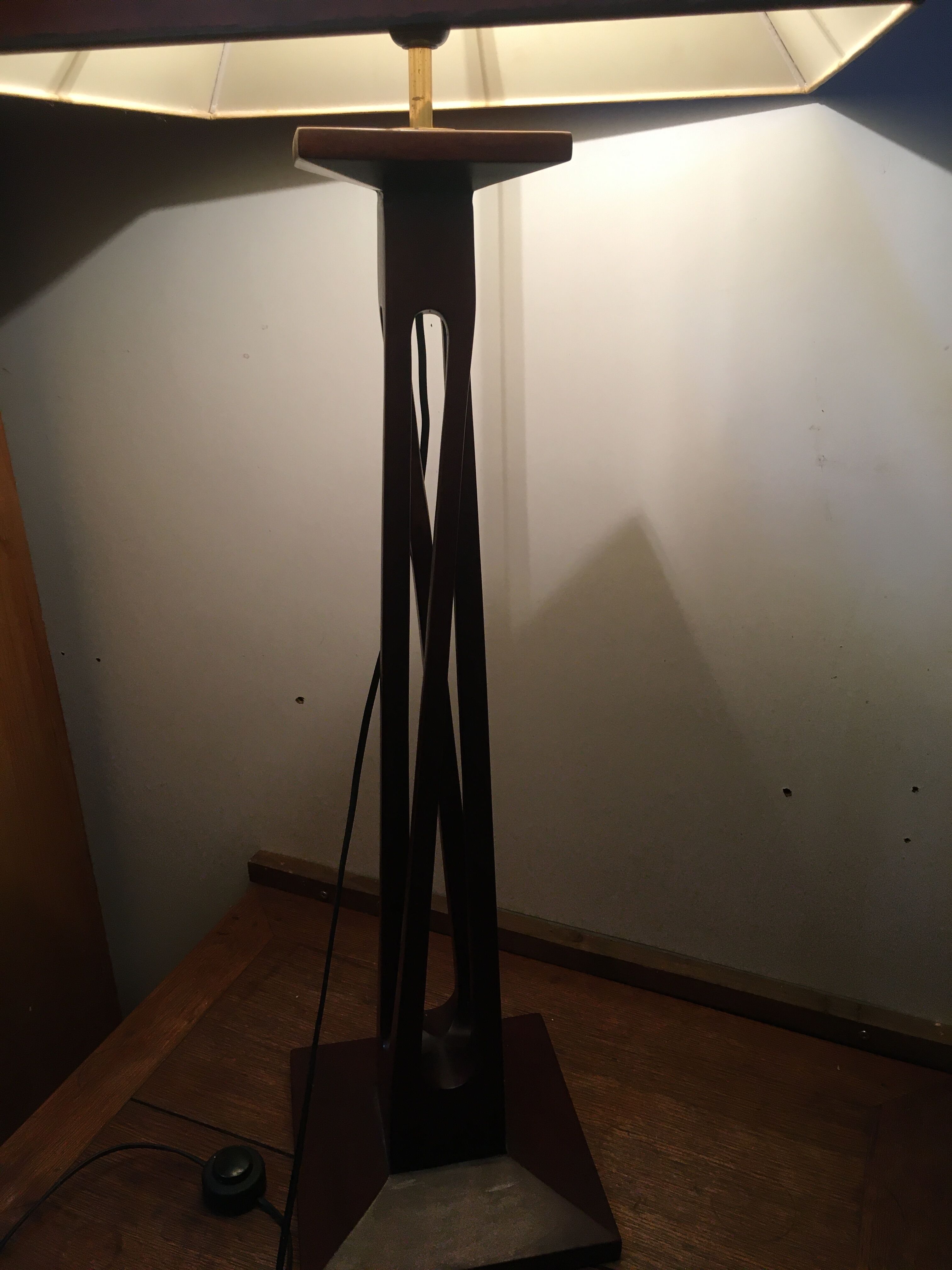 Mahogany lamp with a sculpted base.