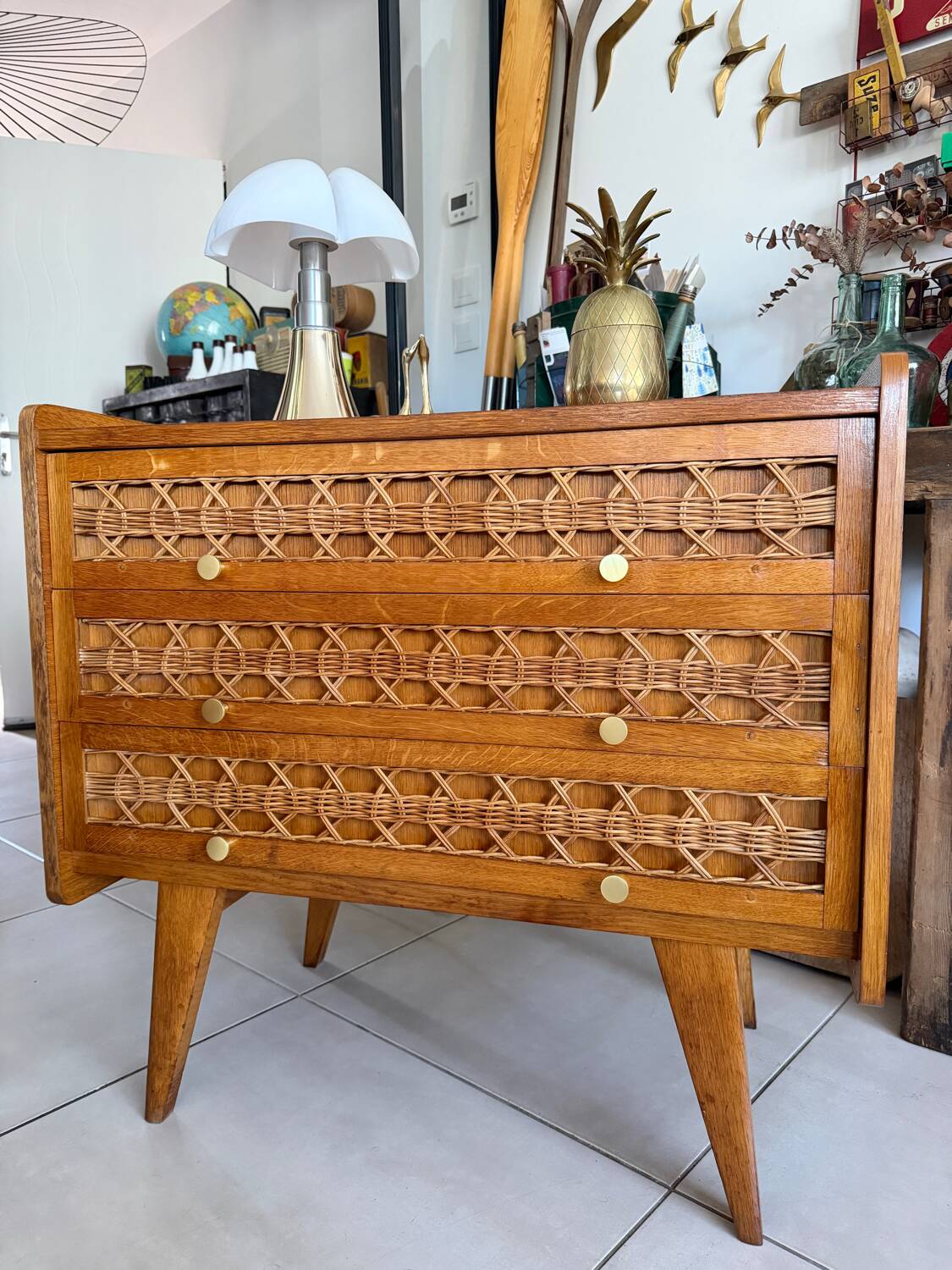 Vintage wooden and rattan chest of drawers with tapered legs.