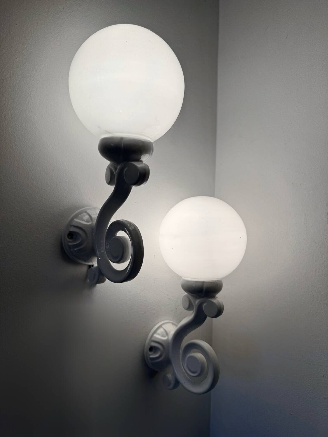 Cast iron and opaline wall lights from the 70s