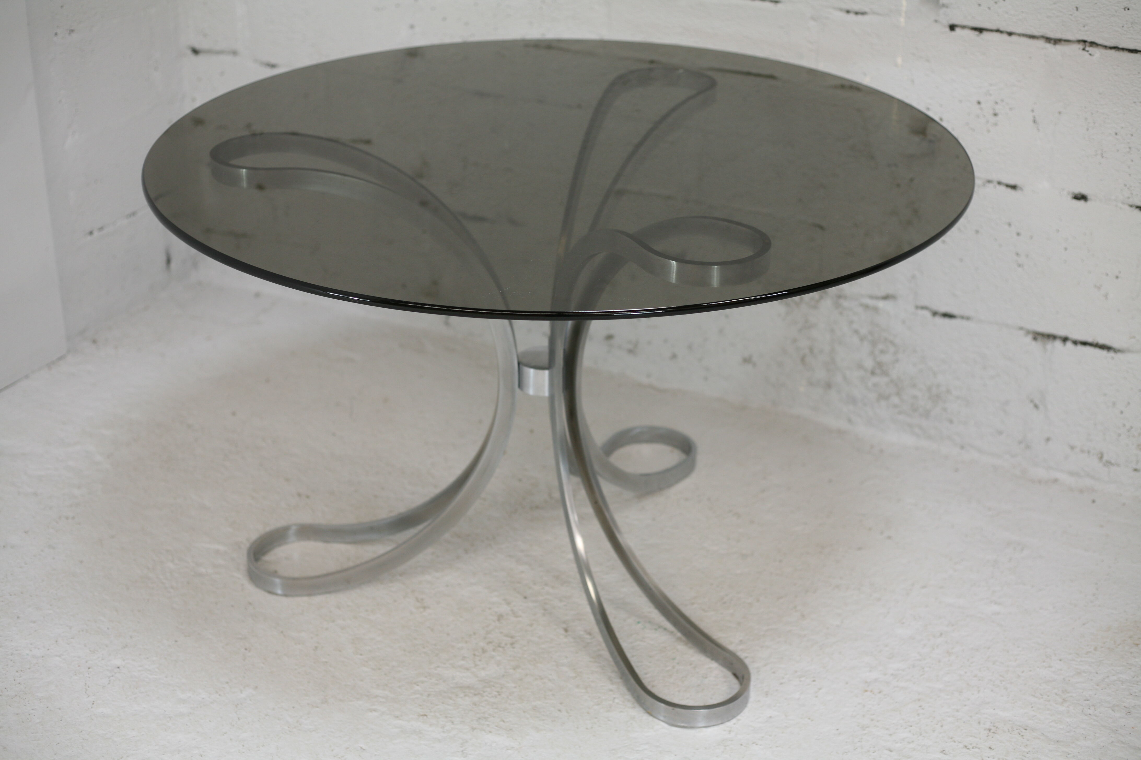 Living room table "Space Age" polished steel, circular slab smoked glass. France, circa 1970.