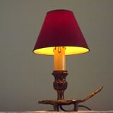 Vintage French bronze Wee Willie Winkie style lamp with red card shade.