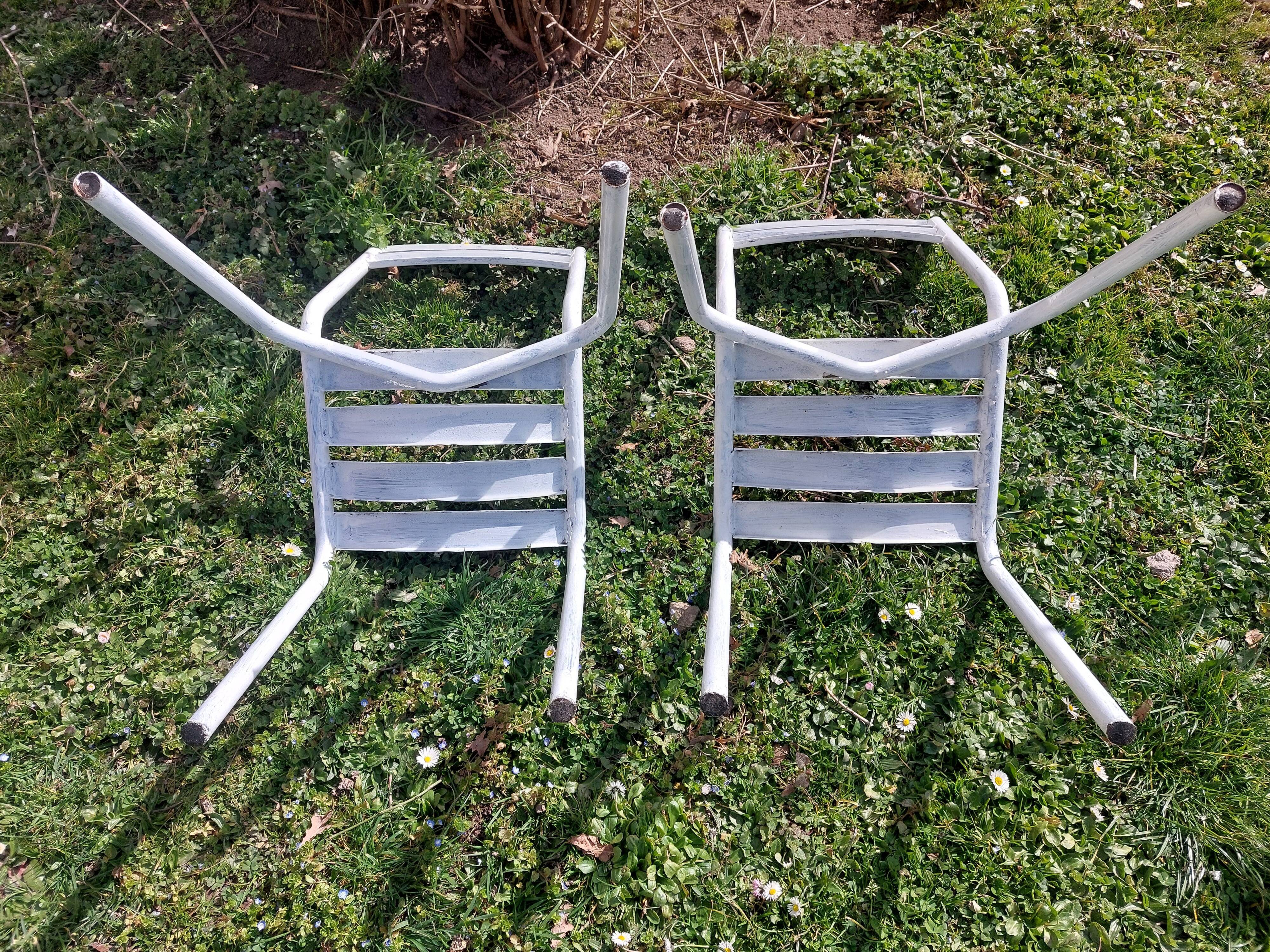 pair of white metal chairs, Tolix style