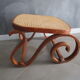 Old inclined footrest in bentwood, wood and canning