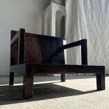 Small low armchair in varnished brown wood