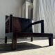 Small low armchair in varnished brown wood