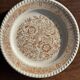 Set of 4 small dessert plates with a vintage stylised flower pattern.